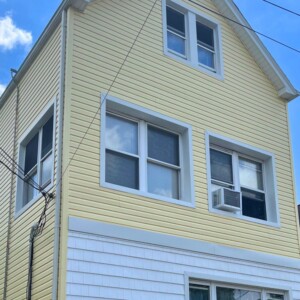 Vinyl dutchlap Siding in the color Autumn Yellow with White trim