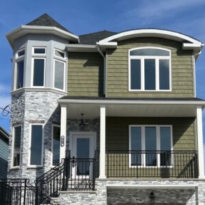 Vinyl shake and Vinyl Dutchlap Siding in the color Olive with White trim