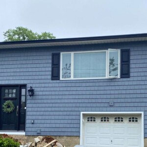 Vinyl Shake Siding in the color Flagstone with white Trim and Black Shutters