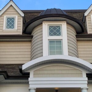 Vinyl Shake Siding in the color Country Beige with Musket Brown Trim and Brown Metal Roof