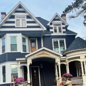 Vinyl Clapboard Siding in the color Indigo, Vinyl Shake in the color Indigo and White Scallops complete with White trim
