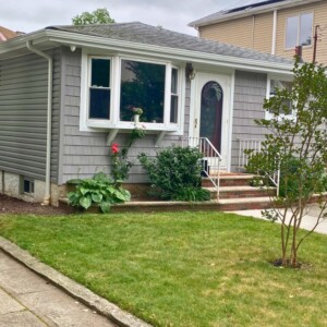 Vinyl Shake with Vinyl dutchlap Siding in the color Gravestone with White Trim