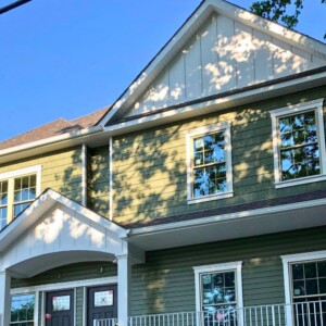 Vinyl Shake and Vinyl Dutchlap Siding in the Color Palm with White Azek representing Board & Batten look with White Trim