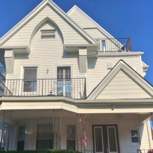 Vinyl Shake Siding and Vinyl Clapboard Siding in the color White with White trim Located in Brooklyn